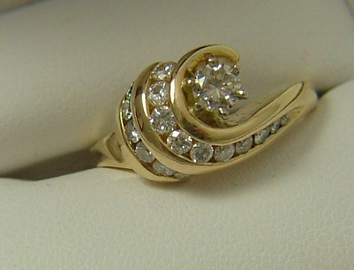 Appraisal: DIAMOND AND FOURTEEN KARAT GOLD RING set with round-cut diamonds