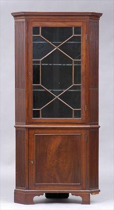 Appraisal: FEDERAL MAHOGANY TWO-PIECE CORNER CABINET The dentil-carved cornice above a