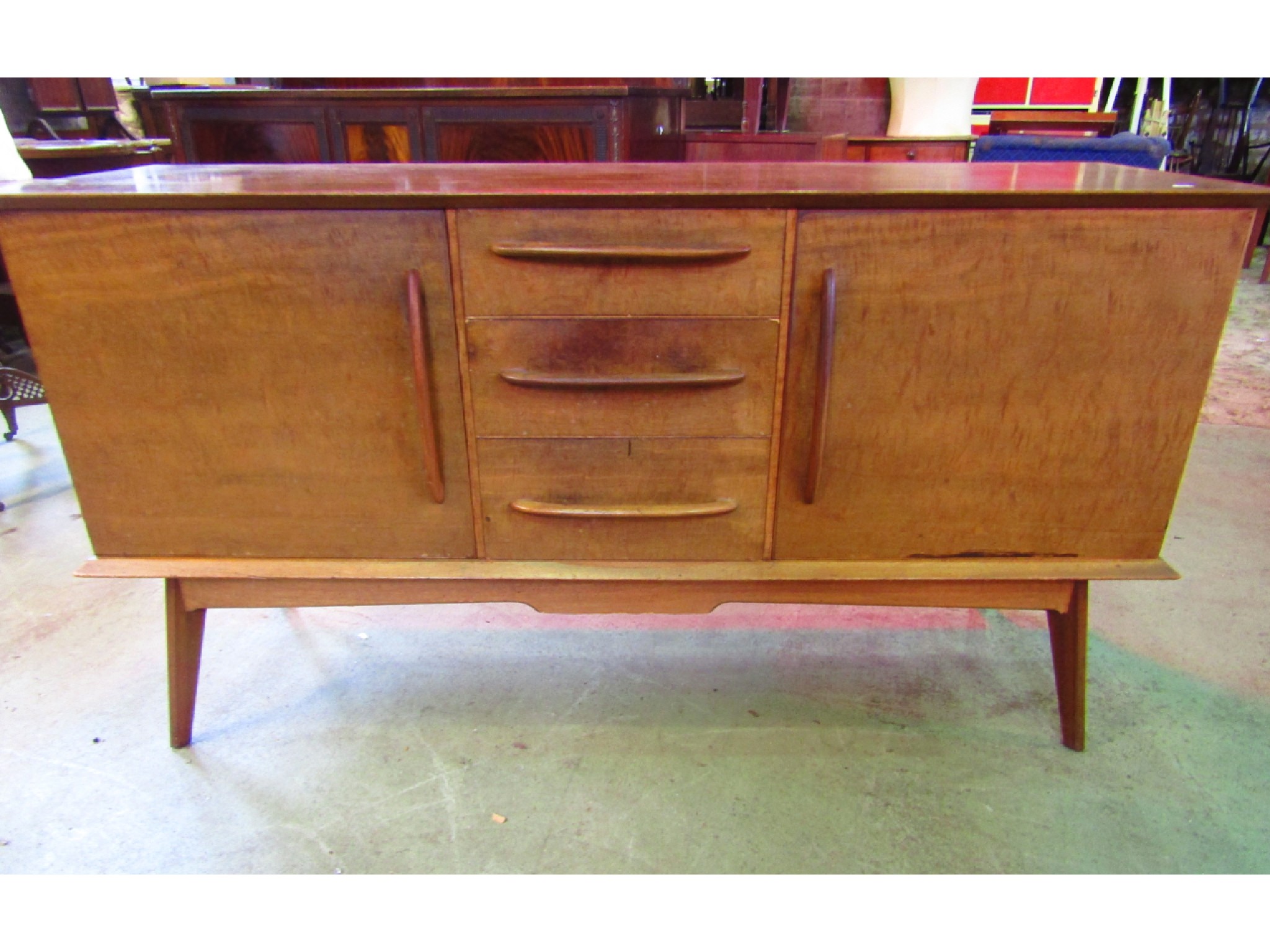 Appraisal: A mid th century Alfred Cox teak sideboard partially enclosed