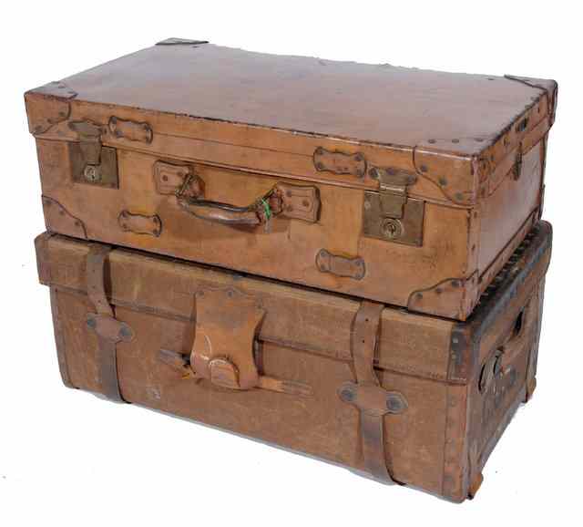 Appraisal: A LARGE LEATHER SUITCASE wide together with a leather bound