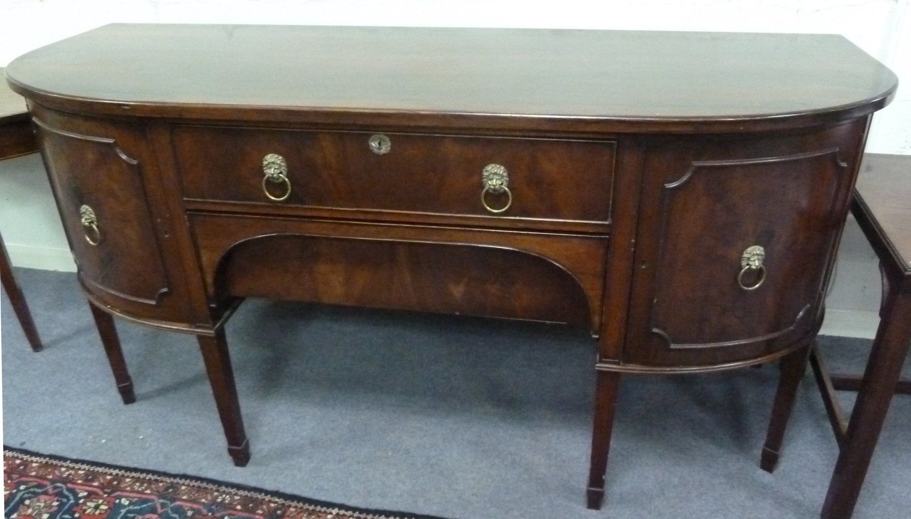 Appraisal: A th Century mahogany bow fronted sideboard on square tapering