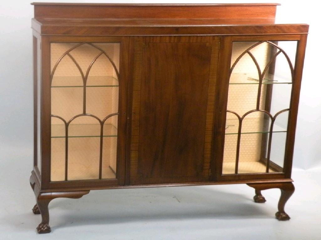 Appraisal: A mahogany display cabinet with a raised back two glazed