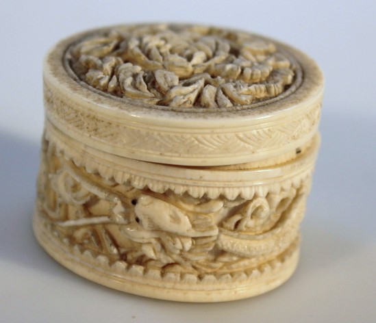 Appraisal: A thC Japanese ivory lidded jar the cylindrical body carved