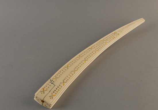 Appraisal: Walrus Tusk Scrimshaw Decorated Cribbage Board with some color in