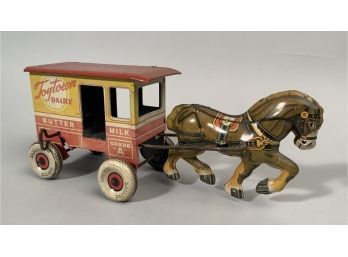 Appraisal: A tin Marx horse drawn dairy wagon with rear winding