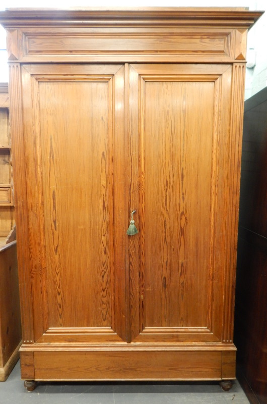 Appraisal: A thC Continental pine wardrobe with two panelled doors a