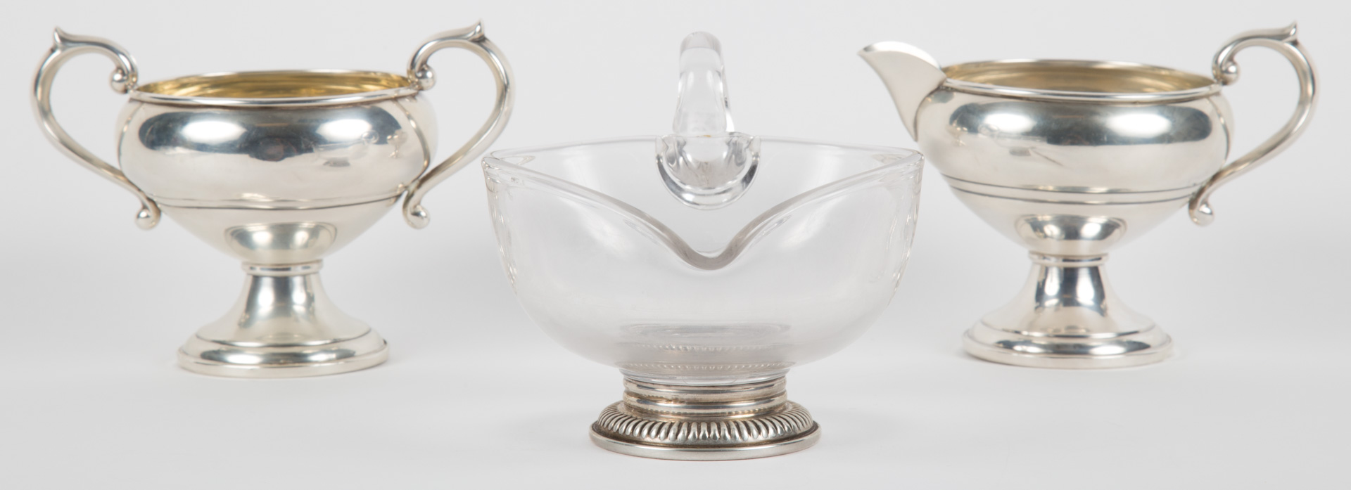 Appraisal: American weighted sterling creamer sugar together with a sterling mounted