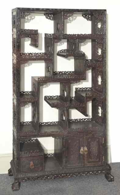 Appraisal: A CHINESE HARDWOOD OPEN CABINET with numerous shelves each having