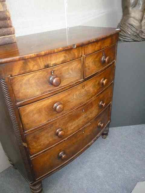 Appraisal: A VICTORIAN MAHOGANY BOW FRONTED CHEST of two short and