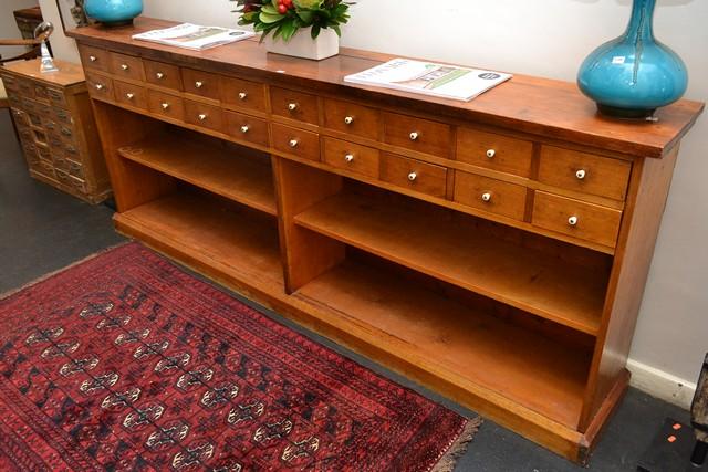 Appraisal: AN IMPRESSIVE INDUSTRIAL OAK SIDE BOARD WITH TWENTY SMALL DRAWERS