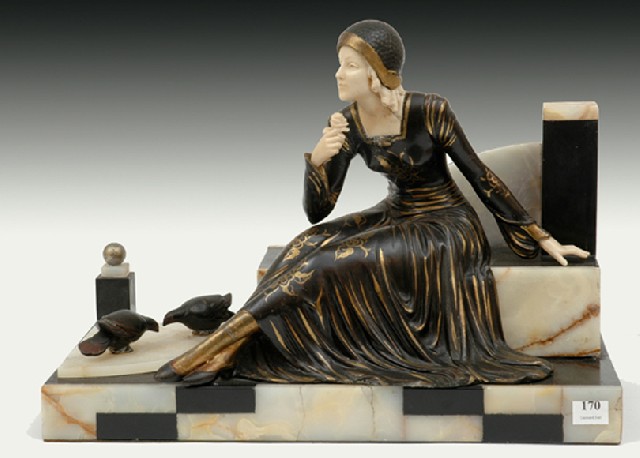 Appraisal: AN ART DECO SPELTER AND IVORINE FIGURE GROUP The seated