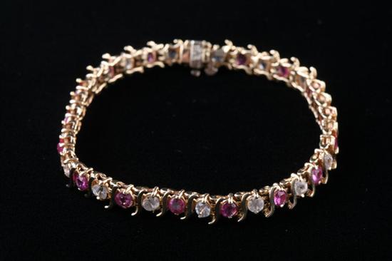 Appraisal: K YELLOW GOLD RUBY AND WHITE SAPPHIRE TENNIS BRACELET round