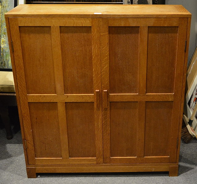 Appraisal: A Cotswold style oak cupboard in the manner of Healscirca