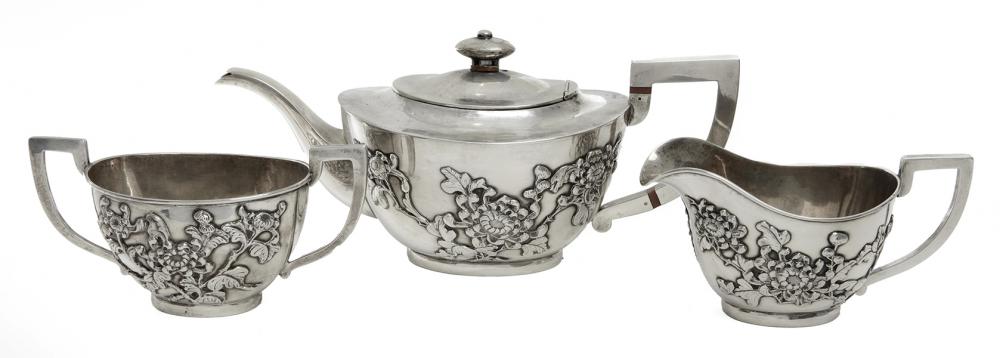 Appraisal: A CHINESE SILVER THREE PIECE TEA SERVICE REPOUSSE PEONY BLOOMS