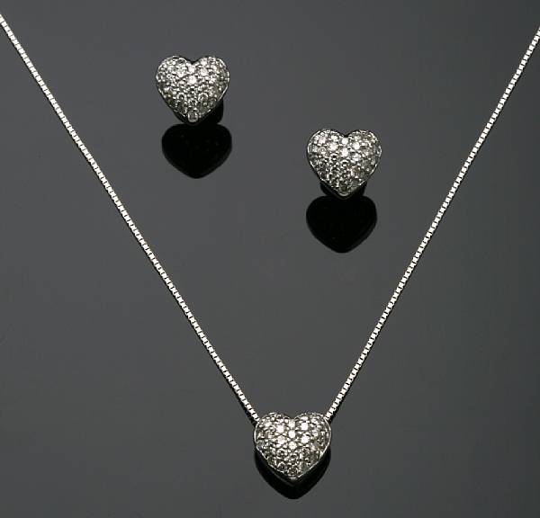 Appraisal: A diamond and white gold heart pendant with chain with