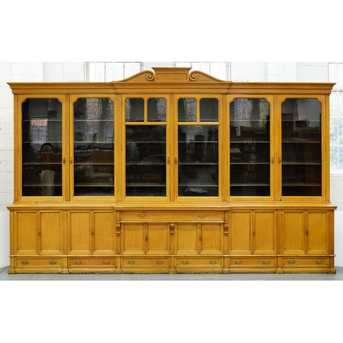 Appraisal: An unusually large Victorian scumbled breakfront bookcase the central pediment