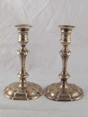 Appraisal: A pair of George II chased cast silver candlesticks the