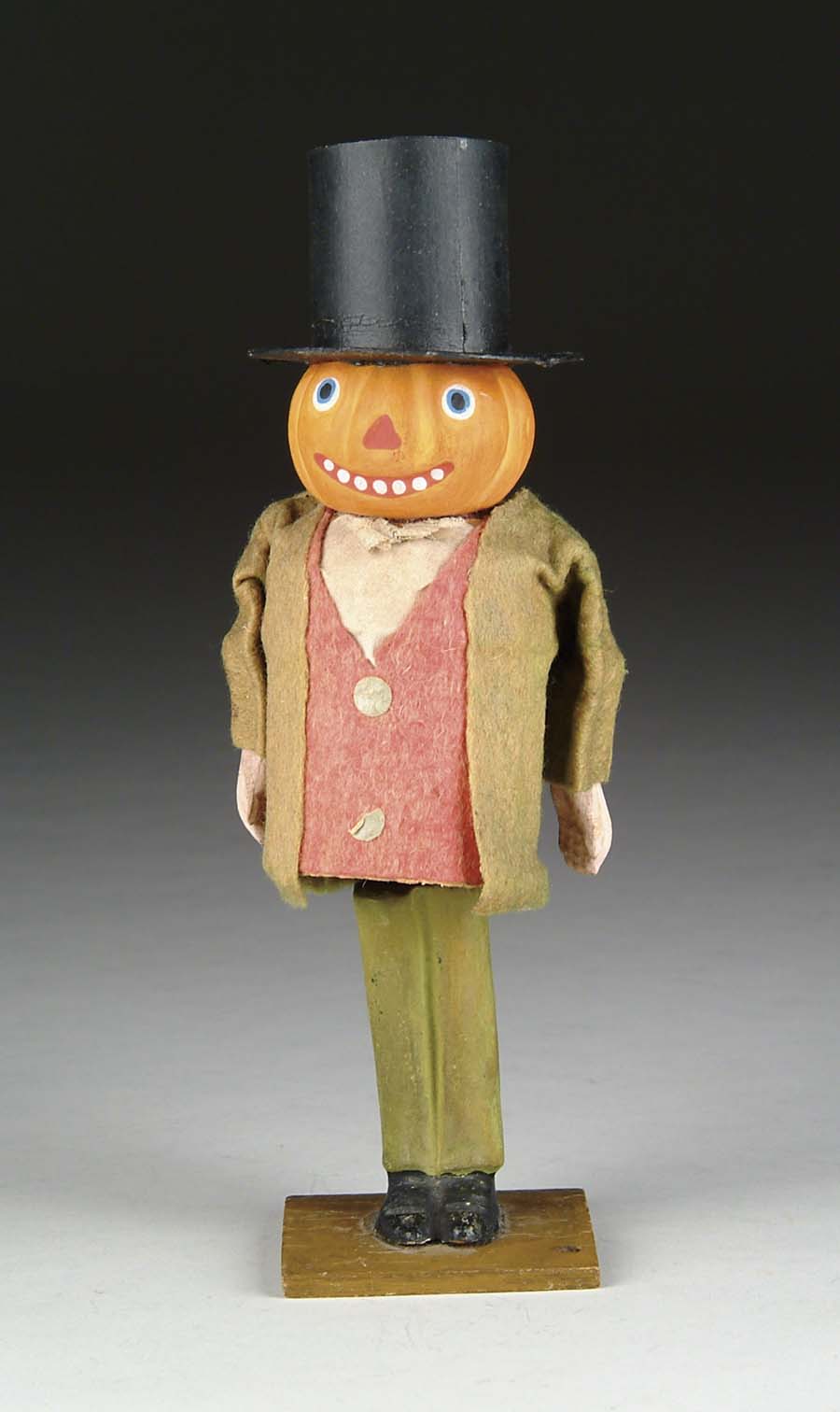 Appraisal: TALL PUMPKIN-HEAD NODDER Felt clothing over cardboard body with composition