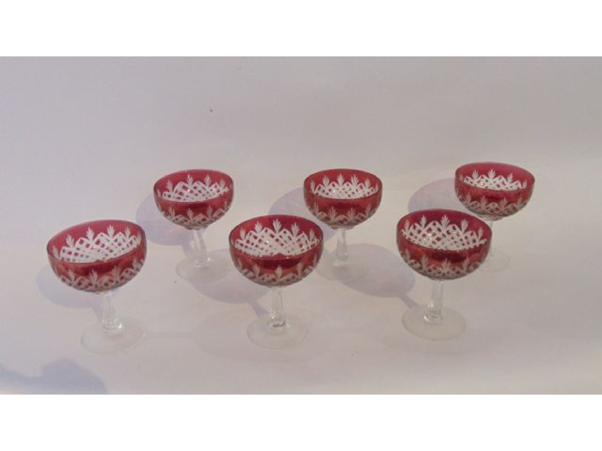 Appraisal: A set of six champagne glasses with cranberry bowls detailed