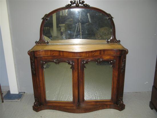 Appraisal: Victorian mahogany mirror backed serpentine chiffonier with carved finial marble