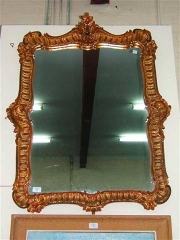 Appraisal: A rococo style pine framed wall mirror wide x high