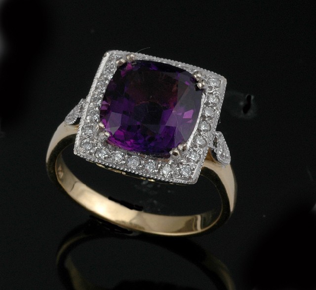 Appraisal: AN AMETHYST AND DIAMOND CLUSTER RING Centrally set with a