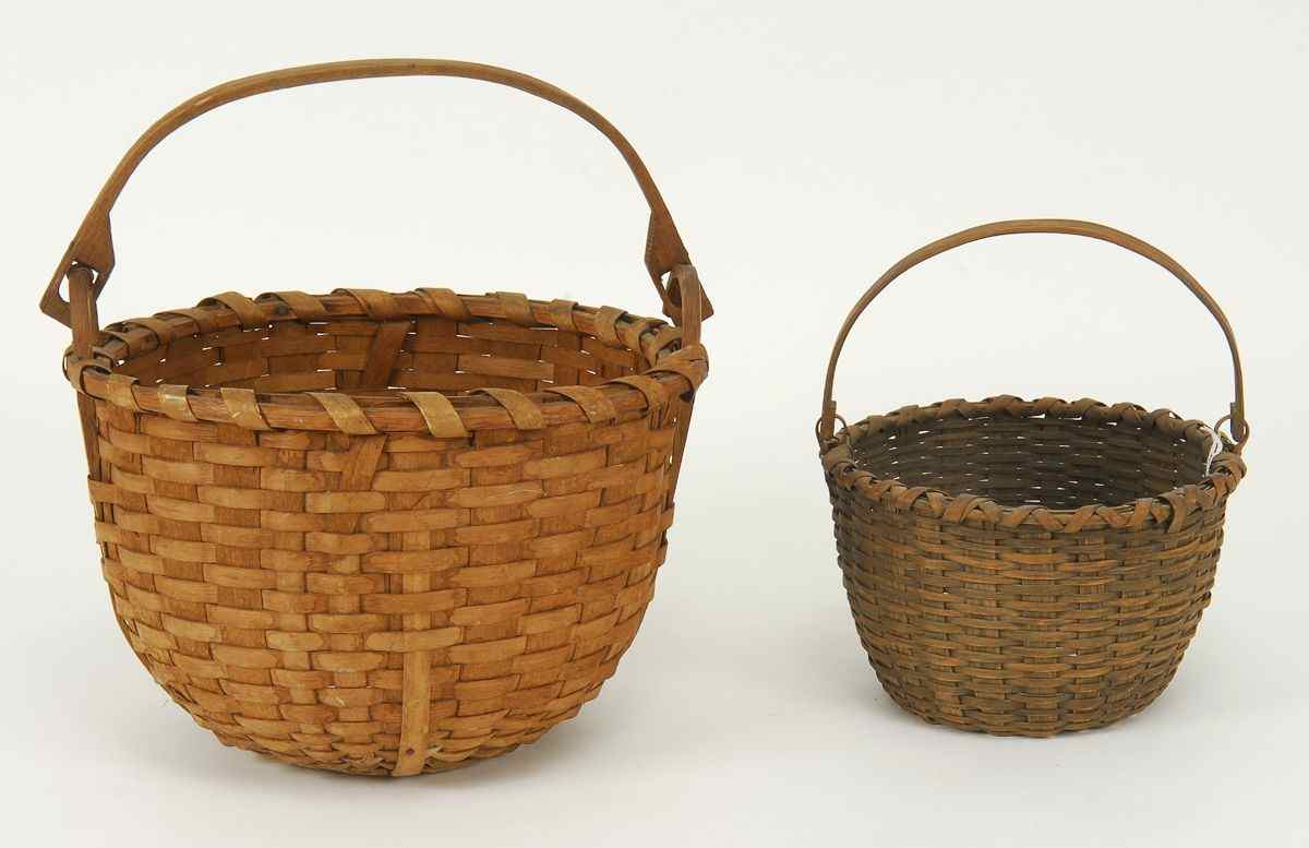 Appraisal: TWO SPLINT BASKETS th CenturyBoth with carved oak swing handles