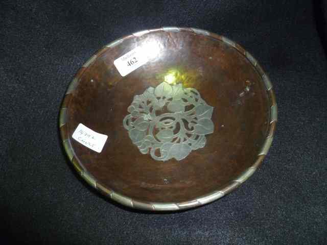 Appraisal: A HUGH WALLIS BEATEN COPPER CIRCULAR BOWL with white metal