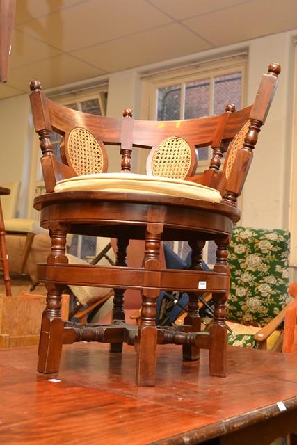 Appraisal: A CIRCULAR THEMED REPRODUCTION CAPTAINS CHAIR