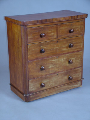 Appraisal: A Victorian mahogany round corner chest of two short and