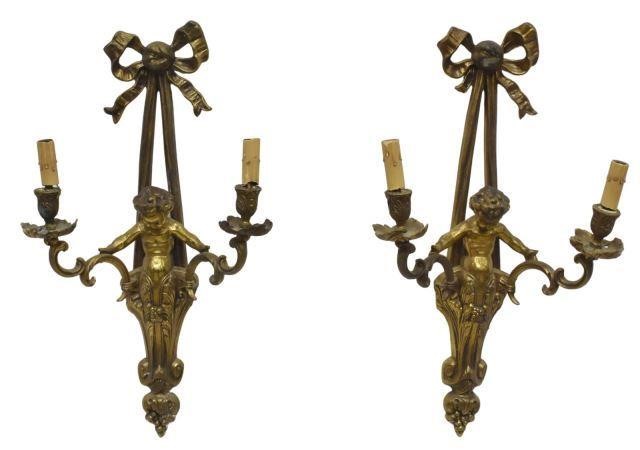 Appraisal: pair French style brass figural wall sconces each centering cherub