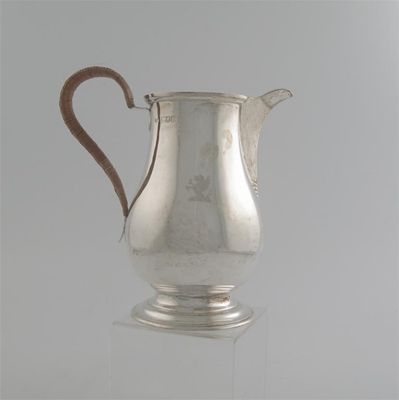 Appraisal: An Edwardian baluster jug on a spreading foot with a