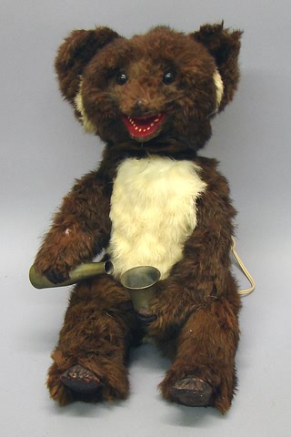 Appraisal: Sitting mechanical bear Bear is covered with brown and ivory