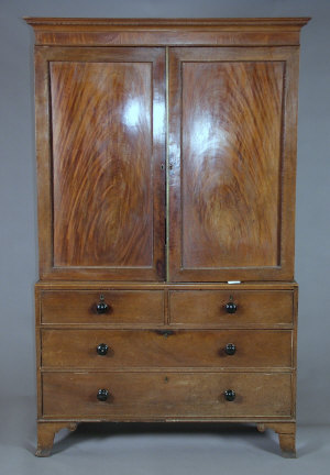 Appraisal: A mahogany linen press mid th century the beaded cornice