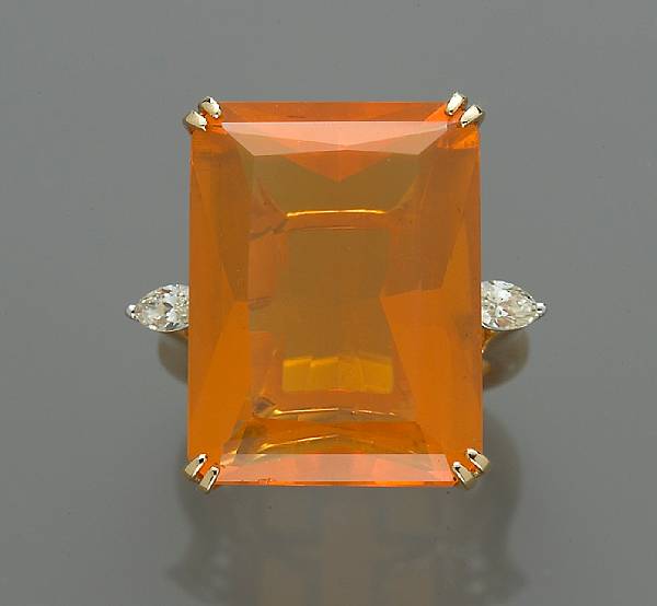 Appraisal: A fire opal and diamond ring centering a rectangular-cut fire