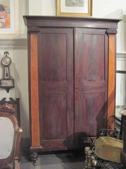 Appraisal: Classical mahogany and tiger maple two panel door wardrobePROVENANCE