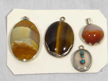 Appraisal: A mixed lot comprising four silver mounted agate pendants