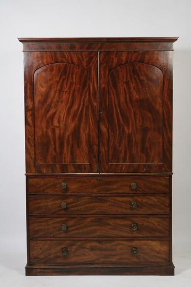 Appraisal: A REGENCY MAHOGANY LINEN PRESS with a moulded cornice above