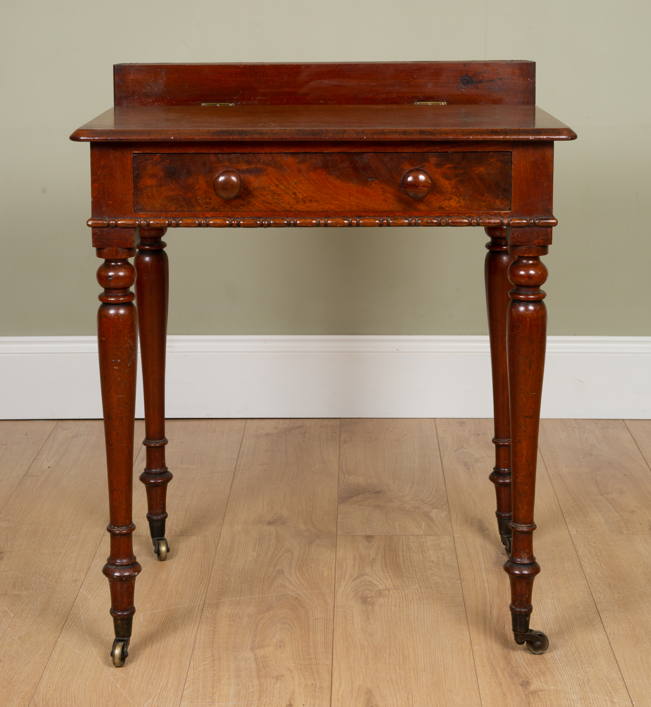 Appraisal: An early Victorian mahogany chamber table with horizontal flap to