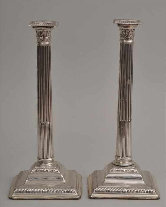 Appraisal: PAIR OF ENGLISH SILVER-PLATED COLUMN-FORM CANDLESTICKS Each stop-fluted stem with