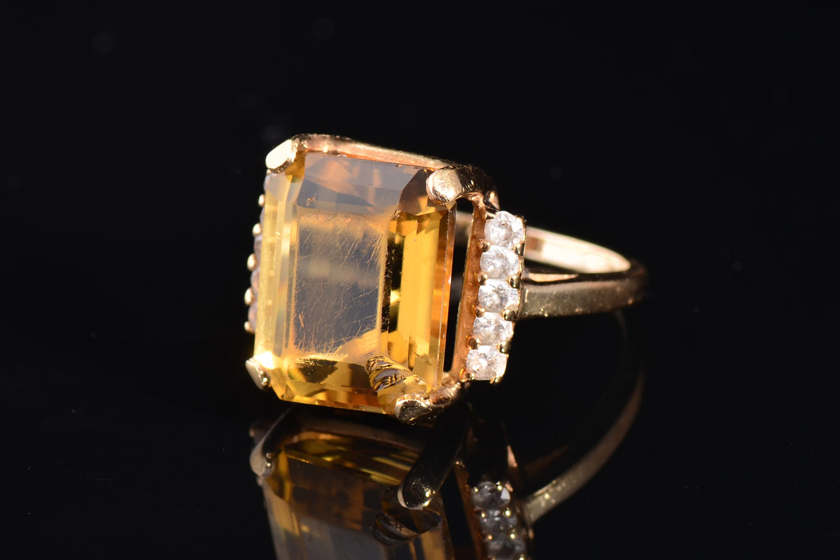 Appraisal: CT CITRINE RING K yellow gold ring centers one emerald