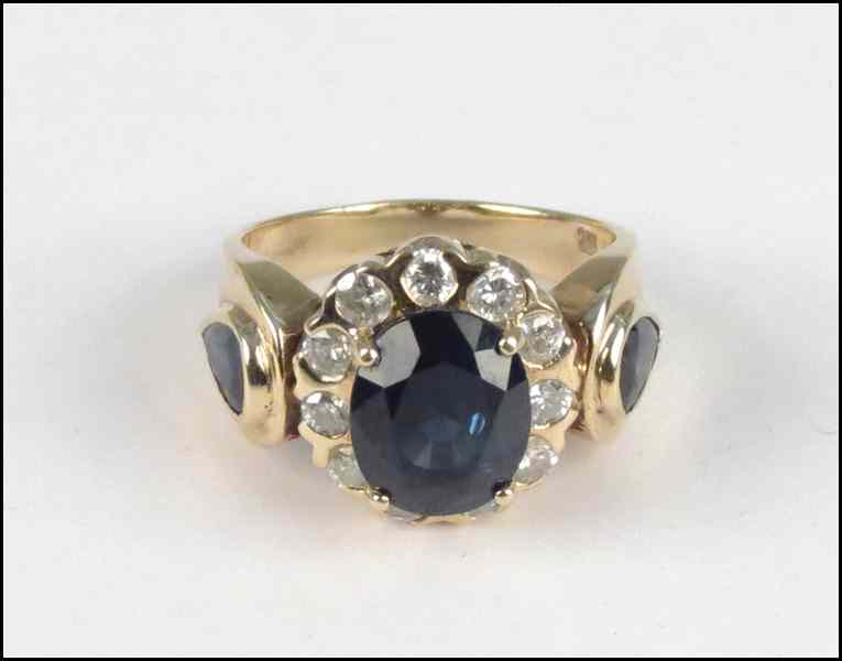 Appraisal: KARAT YELLOW GOLD SAPPHIRE AND DIAMOND RING Central oval sapphire