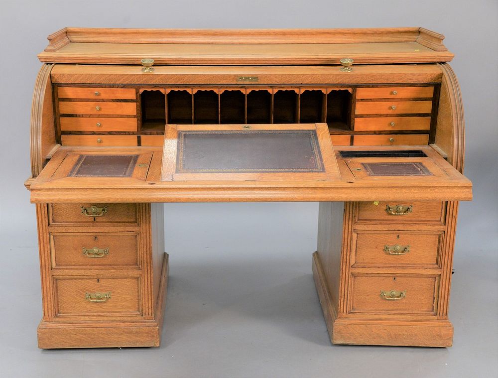 Appraisal: Large oak roll-top desk with fitted interior and leather pull-out