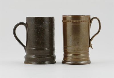 Appraisal: Two brown stoneware cylindrical mugs one with ridged borders late