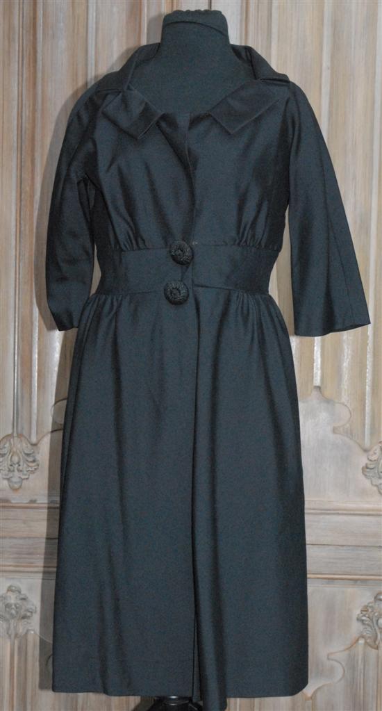 Appraisal: BLACK AFTERNOON DRESS Split cowl and giant buttons at fitted