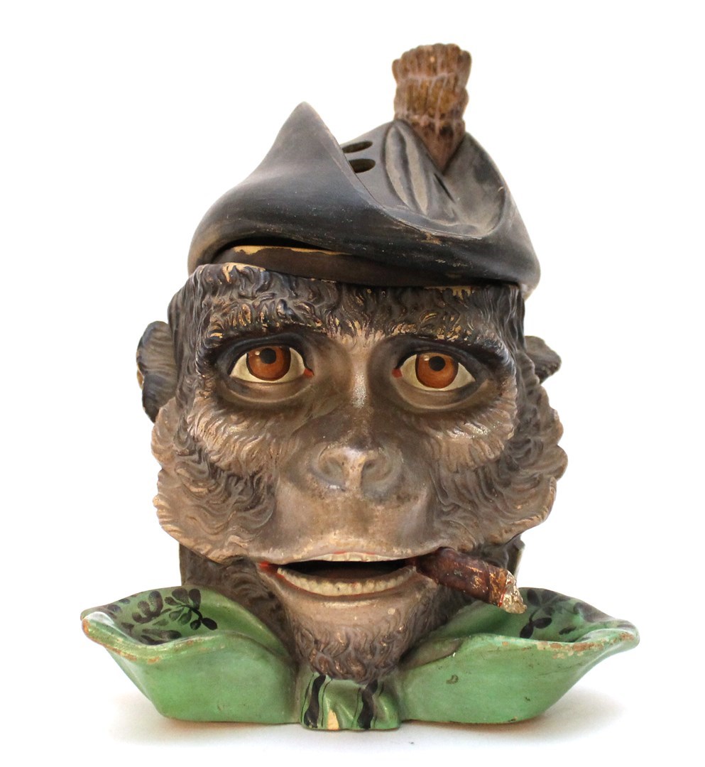 Appraisal: A novelty pottery smokers compendium model of a monkey smoking