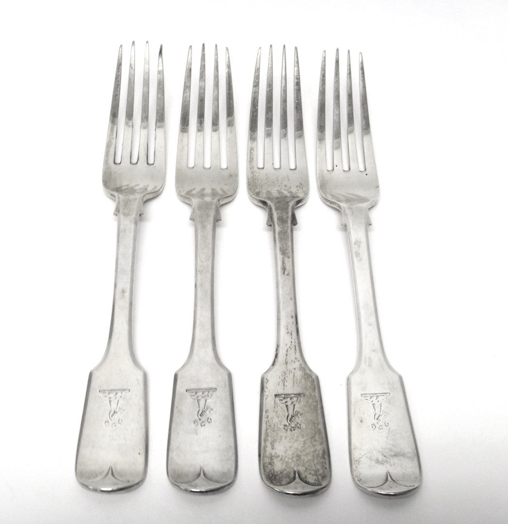 Appraisal: Four Victorian silver fiddle pattern table forks crest engraved London