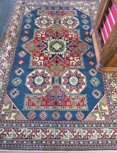 Appraisal: HAND KNOTTED ORIENTAL CARPET Pakistani Caucasian Kazak colorful overall geometric