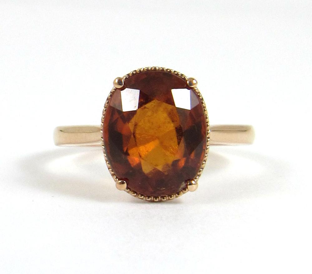 Appraisal: HESSONITE GARNET AND FOURTEEN KARAT ROSE GOLD RING The solitaire