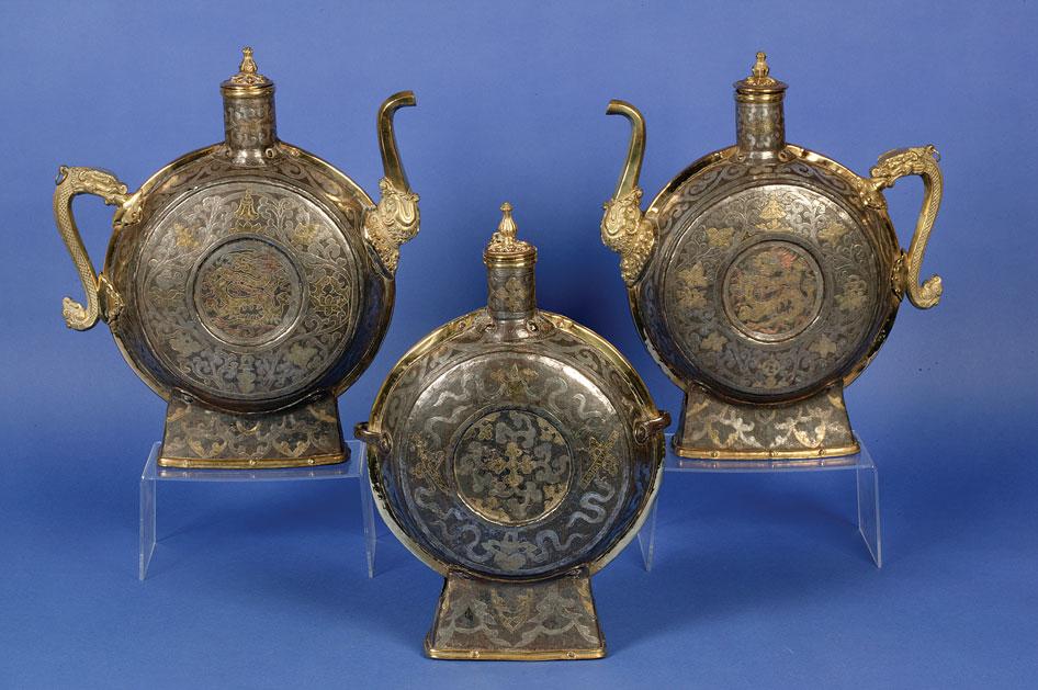 Appraisal: A PAIR OF CHINESE BRASS AND SILVERED METAL MOON EWERS